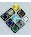 Colorful square watch dials with Roman numerals arranged on a white surface.