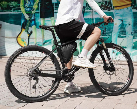 Cyclist riding bike with black On Frame Bike Triangle Bag With Dual Sided Pockets 1.5L Capacity Easy Access Tool Phone And Key Storage
