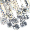 Close-up of crystal glass pendant light with beads, part of modern clear pendant fixture for kitchen island or dining room.