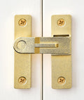 Front view of 180 Degree Flip Barn Door Lock in Gold mounted on a white door showcasing heavy-duty gate latch design.