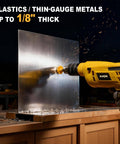 Side view of a yellow KATA drill fitted with a hole saw, cutting through a metal sheet on a workbench