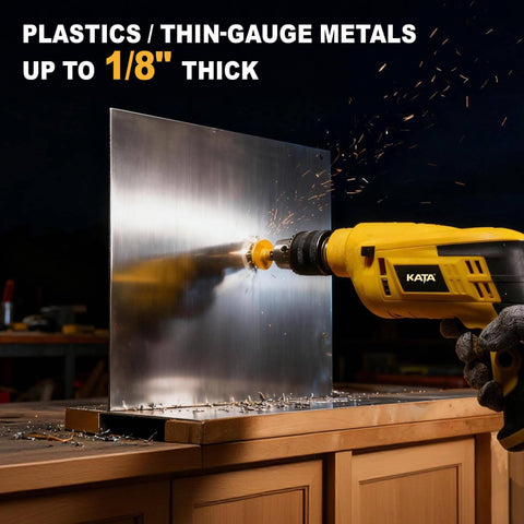 Side view of a yellow KATA drill fitted with a hole saw, cutting through a metal sheet on a workbench