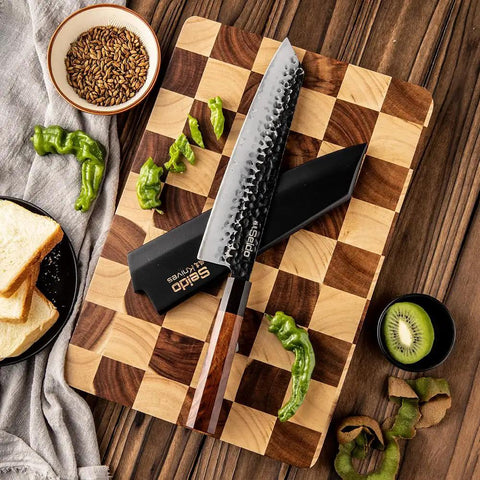 Kiritsuke Knife Cover With Walnut Magnetic Sheath For 10 Inch Blades on checkered board with vegetables