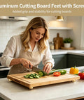 Woman using wooden board with 8 pcs aluminum cutting board feet with screws round 1.18 by 0.39 in silicone rubber pads in kitchen