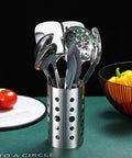 Stainless Steel 13 Piece All In One Kitchen Utensils Set With Holder Nonstick Heat Resistant Dishwasher Safe Easy To Clean Includes Ladle Skimmer Slotted Turner Pasta Server Cooking Spoon Potato Masher Egg Whisk Slotted Spoon Tong Flat Turner Spatula displayed in holder.