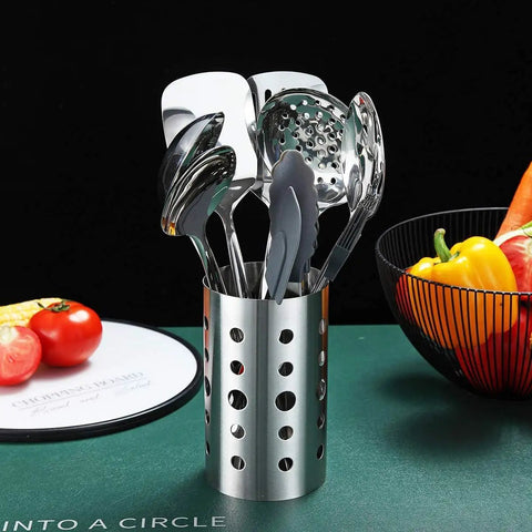 Stainless Steel 13 Piece All In One Kitchen Utensils Set With Holder Nonstick Heat Resistant Dishwasher Safe Easy To Clean Includes Ladle Skimmer Slotted Turner Pasta Server Cooking Spoon Potato Masher Egg Whisk Slotted Spoon Tong Flat Turner Spatula displayed in holder.