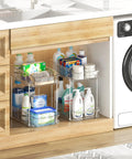 Slick Clear Under Sink Organizers And Storage Bins 2 Pack with cleaning supplies and toiletries stored in a kitchen cabinet.