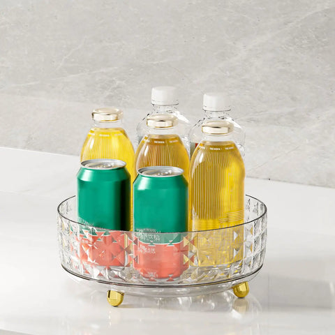 Non Slip Lazy Susan Turntable 9 Inch Clear One Tier Spinning Organizer For Kitchen Pantry Cabinet And Refrigerator, holding bottles and cans.