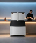 Heavy Duty Commercial Ice Maker Pumping Out Crisp Clear Cubes On The Fly With Stainless Steel Frame in bar setting.