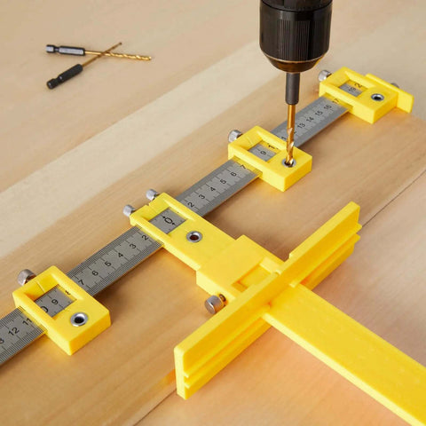 Adjustable Cabinet Hardware Drill Guide Jig With Quick Release Template For Doors And Drawers Bullseye Punch Locator Nail Straight Every Single Time Support Up To 16 Inch Pulls with drill bit on a wooden surface.