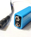 9V Battery Replacement Eliminator Kit For Smoke Detectors Fire Alarms Carbon Monoxide Detectors Bedside Radios Multimeters And Other Electronics No Fuss Plug And Play Power Solution With A 120V AC Wall Adapter And An Active Dummy Cell, showing blue dummy cell and connector.