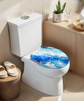 Elongated Alcohol Abstract Indigo White Gold Stains Stains Toilet Seat on a white toilet, showcasing blue and gold resin design.