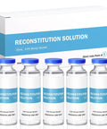 Front view of five 30ml glass vials with blue caps labeled Reconstitution Solution, arranged in a white and blue box.