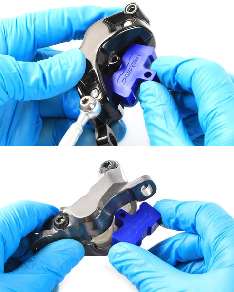 Hands installing All In One Pro Grade Hydraulic Disc Brake Pad Spacer Set With Three Styles Bleed Blocks And Pad Spreader Tool.
