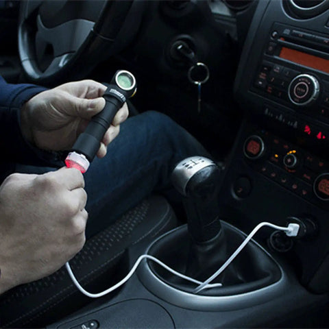 Wizard Pro V3 XHP50 Warm USB Magnetic Headlamp With 2300 Lumens Beast Brightness being charged in car with magnetic USB cable