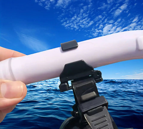 Hand holding 8 Pack Dope Snorkel Keeper Clips Set For Snorkeling And Scuba Gear against ocean background, durable and odor-free design.