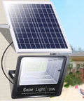Heavy Duty Solar Flood Lights Featuring Wireless Remote Control And Totally Waterproof Led Arrays Backyard Security And Garden Accent Lighting That Definitely Slays In Pitch Black Settings mounted on a wall with solar panel.