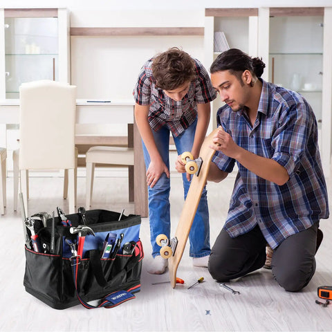 Two people working on a project with a 18 Inch Open Top Tool Bag With Waterproof Molded Base, 20 Pockets, and Adjustable Shoulder Strap nearby.