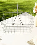 Heavy Duty Iron Shopping Basket With Cushioned Ergonomic Handle Straight Up Durable Grocery Tote For Home Market And Kitchen Runs No Sweat Heavy Load Errand Caddy placed on a table outdoors.