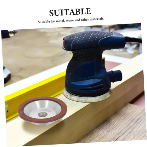 Pro Diamond Cup Grinding Wheel 100mm Silver Concave Bowl on a workbench with sander, suitable for shaping various materials.