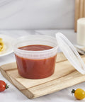 16-Ounce To-Go Food Storage Containers with lids, BPA free, filled with tomato soup on wooden board, microwave safe