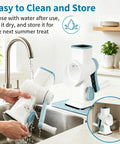 Manual Ice Shaver With 16 Stainless Steel Blades being rinsed under tap, emphasizing easy cleaning feature in a kitchen setting.