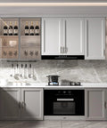 Modern kitchen with 10 Pack 3 Inch Hole Center Cabinet Handles In Black And Gold Matte Finish installed on white and gray cabinets.