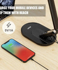 LED Desk Lamp With Eye Caring Light 72 LEDs 9 Brightness Levels 5 Color Modes USB Charging Touch Control And Memory 10W Reading Light For Your Home Office Black with a phone charging on the USB base.