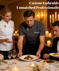 Premium Heavy Duty Cotton Blend Custom Embroidered Short Sleeve Chef Jacket For Cooks Featuring A Sleek Black Cut Hella Breathable Mesh Panels And Pro Kitchen Grind Workwear Fit worn by chefs in a fine dining setting.