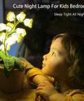 Child mesmerized by Crochet Lily of the Valley Lamp, Handmade Cordless Night Light with Touch Control, cozy bedside decor.