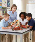 Remote Control Robot Arm Kit For Kids Build Your Own Mechanical Arm With 360 Degree Rotating Gripper Hands On STEM Toy For Learning And Creative Engineering Fun wooden robot arm on classroom table with kids and teacher