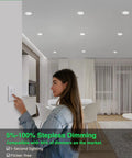 Woman adjusting dimmer switch for 24 Pack Of 4 Inch Led Recessed Ceiling Lights With 5Cct Dimmable Controls And Easy Color Adjustment.