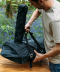 Man adjusting Karu 12 And Karu 2 Carry Cover Waterproof Weatherproof Shield For Pizza Ovens On The Go Grilling Lightweight Elastic Cover