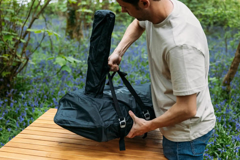 Man adjusting Karu 12 And Karu 2 Carry Cover Waterproof Weatherproof Shield For Pizza Ovens On The Go Grilling Lightweight Elastic Cover