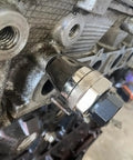 Broken Stud Remover Tool Three Eighths Inch Bolt And Stud Extractor installed on engine manifold for damaged studs removal