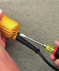 Hands adjusting cable on Powerful 9 Amp Four And A Half Inch Angle Grinder With Paddle Switch And 12,000 RPM Motor, ACDC Compatible.