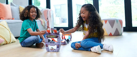 Kids playing with Star Wars RacerVerse Grogu's Great Race Track Set With Two Die-Cast Racers Inspired By The Mandalorian in living room.