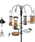 Six Hook Bird Feeding Station With Steel Multi Feeder Stand Four Feeders Bird Bath Mesh Tray And Squirrel Guard Baffle Weatherproof Yard Setup For Attracting Wild Birds On A Sturdy Ninety Four Inch Pole, shown with various feeders and birds.