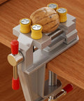Heavy Duty 360 Degree Swivel Cast Iron Bench Clamp for Home Workshop and Metal Fabrication holding a walnut on a wooden workbench