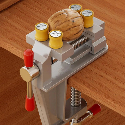 Heavy Duty 360 Degree Swivel Cast Iron Bench Clamp for Home Workshop and Metal Fabrication holding a walnut on a wooden workbench