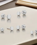 Implant Grade F136 Titanium Dot Stud Earrings Featuring Secure Screw Back Flat Posts, silver studs on a light background.
