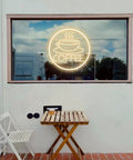 Coffee Cup Neon Sign USB Powered LED Light With 3D Engraved Art displayed on an outdoor window of a cafe.