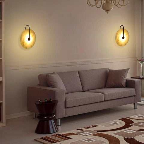 Living room with Nordic Style Stone Wall Lamp With Alabaster Finish, Metal Base Indoor Sconce, cozy glow above sofa.