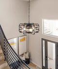 Dope Industrial Black 4 Light Cage Chandelier in hallway with staircase, vintage lantern look, E26 base, ceiling mounted.