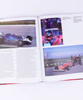 Open book showing Rivals Of The Track F1s Greatest Duels Volume 4 with race car photos and text in Formula One rivalry focus.