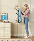 Heavy-Duty Metal Coat Rack With Eight Hooks, Three Adjustable Heights, Modern Hall Tree, Freestanding Clothes Stand With Sintered Stone Base, Built To Be Your Entryway Workhorse For Coats Hats Bags And Scarves, Black next to woman organizing clothes