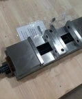 Six Inch Double Lock Cnc Machine Vise With Hardened Steel Bed And Reversible Step Jaws For Heavy Duty Fabrication, top view showing locking handle.