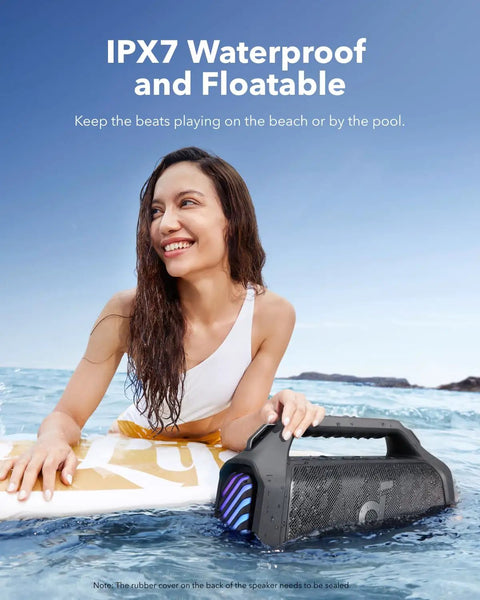Boom 2 Plus Portable Speaker With 140W BassUp 2.0 held by a woman in a pool, demonstrating its IPX7 waterproof feature.