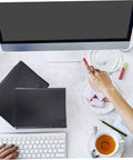 25 Pack Black Bubble Mailers Padded Envelopes Beefed Up Thickened Poly Bubble Packaging Bags on desk next to keyboard and tea