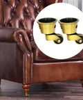 Vintage Zinc Alloy Swivel Casters 2 Pack, 1-3/4 Inch OD, Antique Brass Bronze Finish on a leather chair